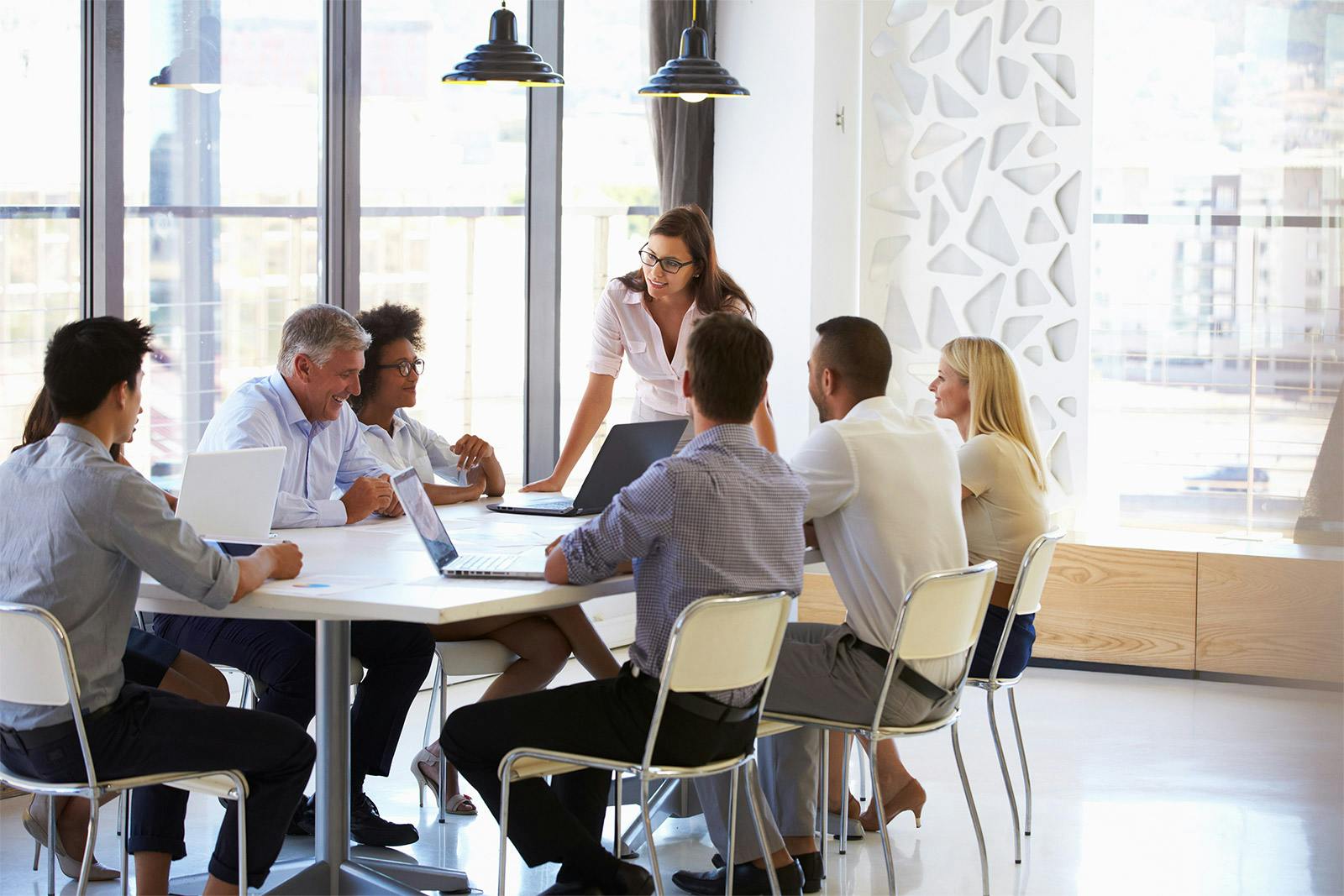 executive leading a meeting with her team