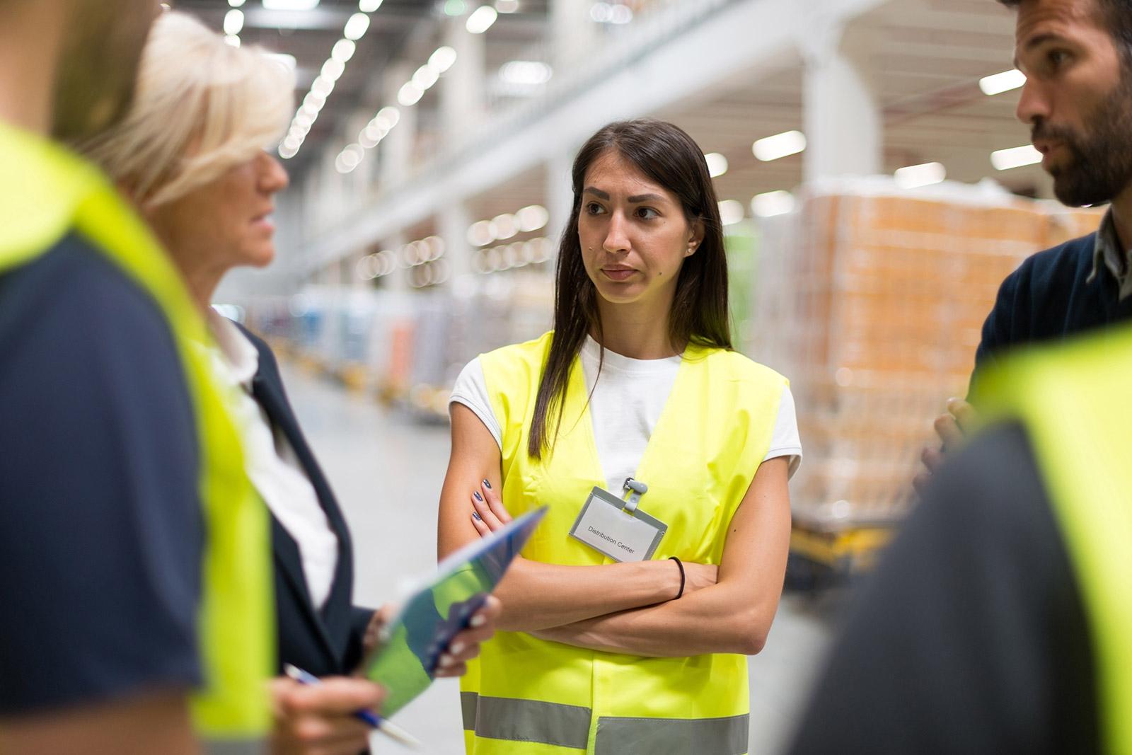 warehouse with boxes of merchandise, older woman directing the work