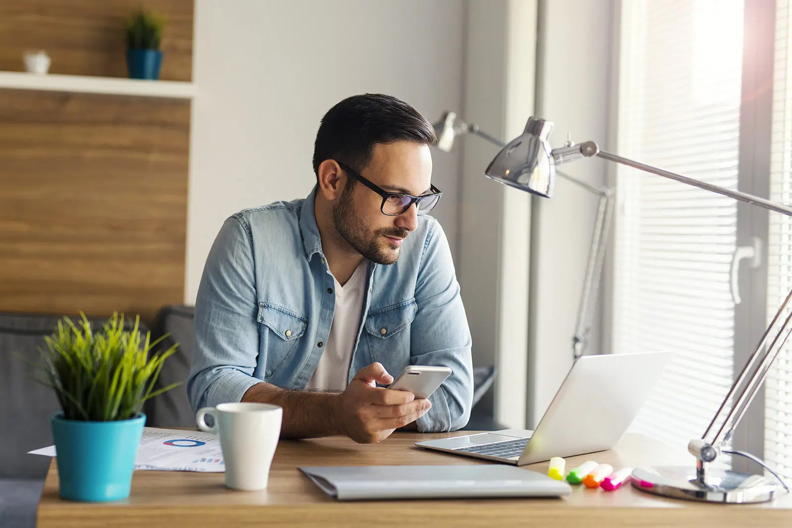 man with glasses looking at the computer