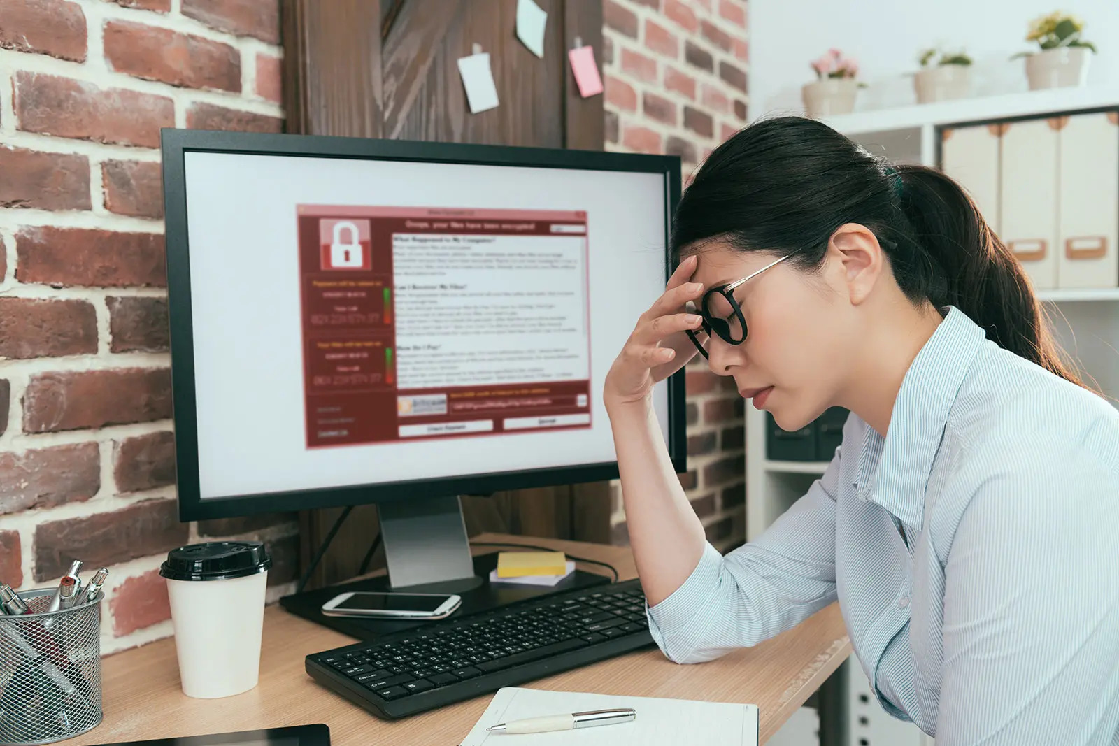 office worker with a virus on her computer.
